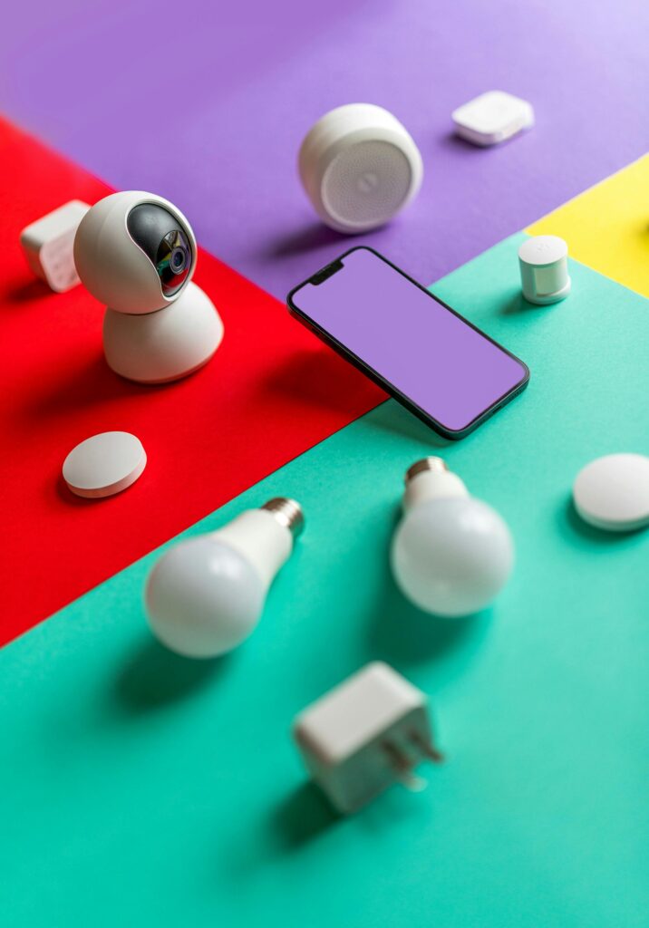 Modern smart home gadgets displayed on a colorful abstract background with vibrant lighting.